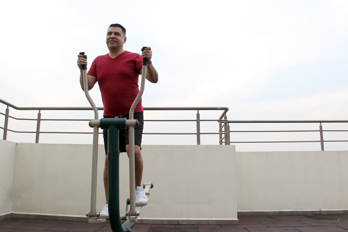 Adult male exercises in an outdoor gym to manage type 2 diabetes and obesity.
