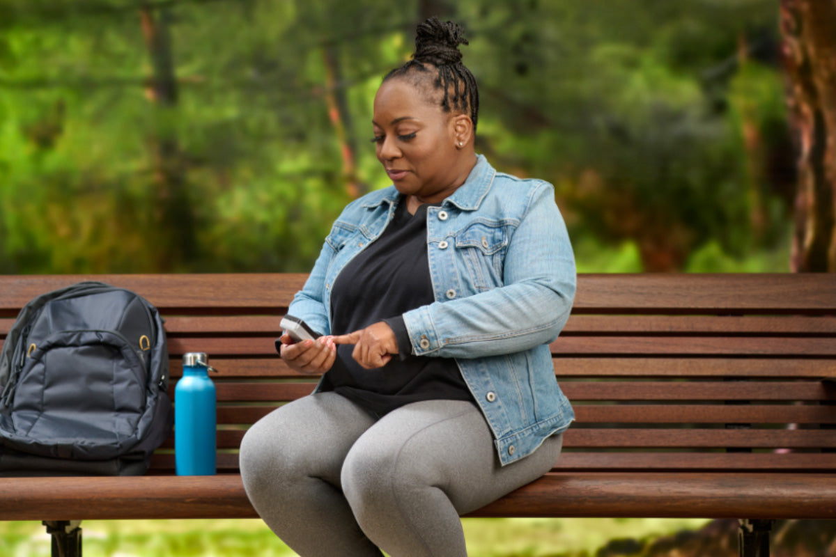 Lady on bench following type 2 diabetes monitoring guidelines